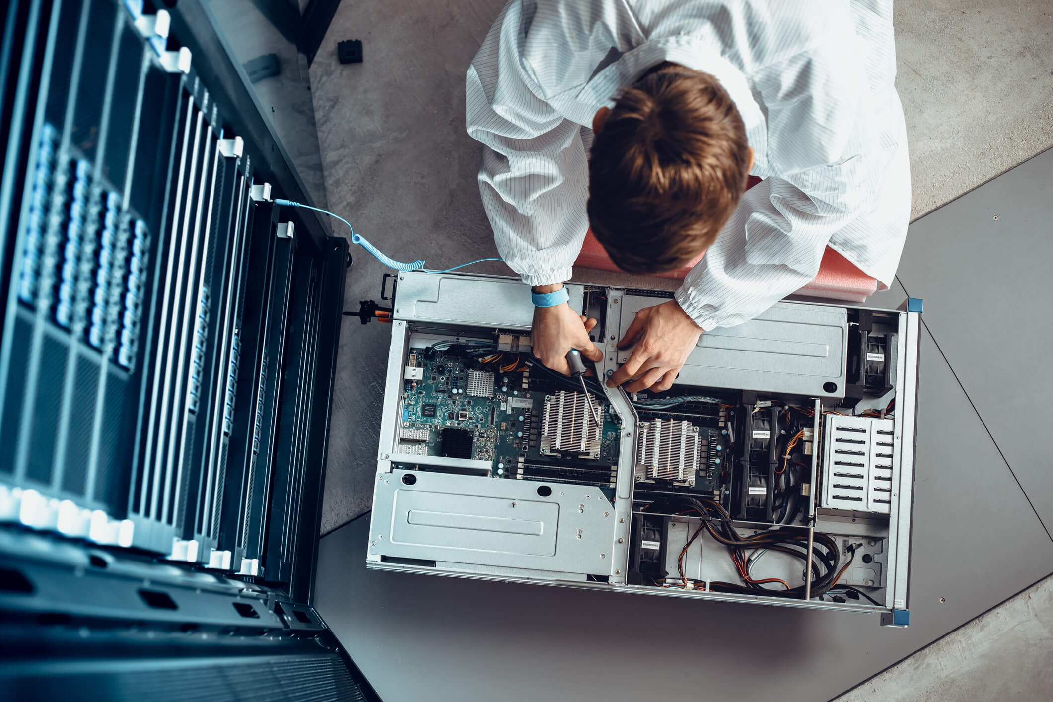 Man working on fiber-optic equipment