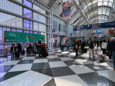 Intersect Illinois billboard in O'Hare Airport with passerby